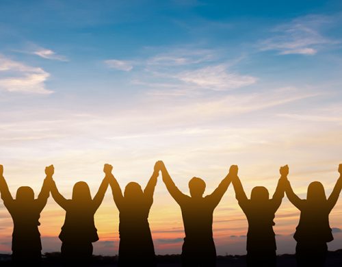 Silhouette of group happy business team making high hands over head in beautiful sunset sky evening time for business success and teamwork concept in company